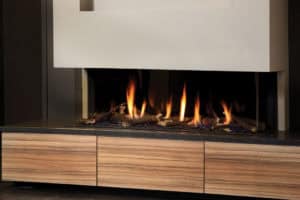 Gas Fire Installation in Kent | Coeval Fires 9 Gas fireplace with modern design and wooden cabinetry, perfect for cosy living rooms.