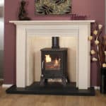 Traditional fireplace with a black wood stove and white mantel in a cosy living room.