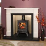 Wood burning stove in a stylish living room fireplace.